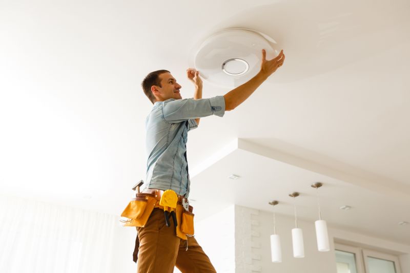 Handyman installing a light fixture